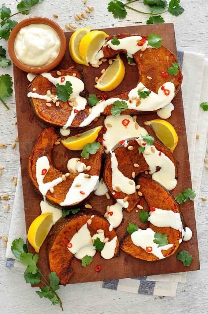 Cinnamon Roasted Pumpkin dressed with yoghurt and pine nuts, overhead photo