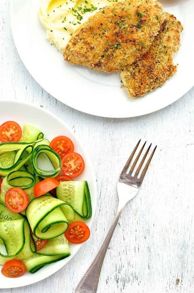 Super Quick Chicken Dinner of crunchy broiled / grilled chicken, mashed potato and side salad on a white plate, ready to be eaten.