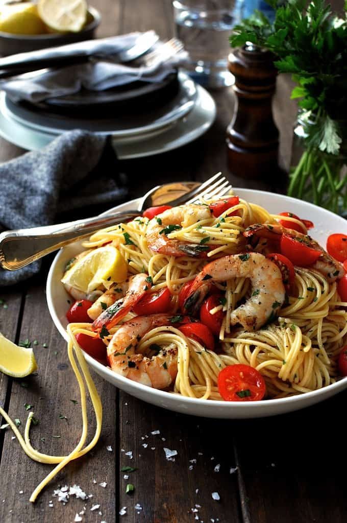 A bowl of Prawn Pasta with cherry tomatoes and lemon
