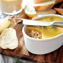 Elegant Smoked Trout Dip in a small white dish with bread on the side.