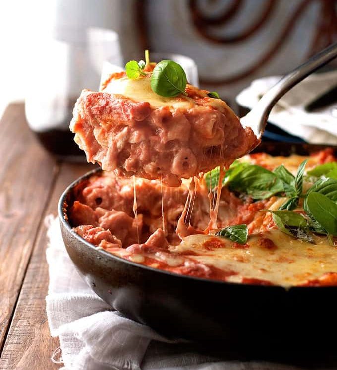 A scoop of Creamy Tomato Pasta Bake With Chicken