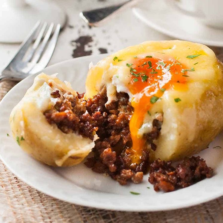 Close up of sausage spilling out of Sausage Egg Stuffed Potatoes