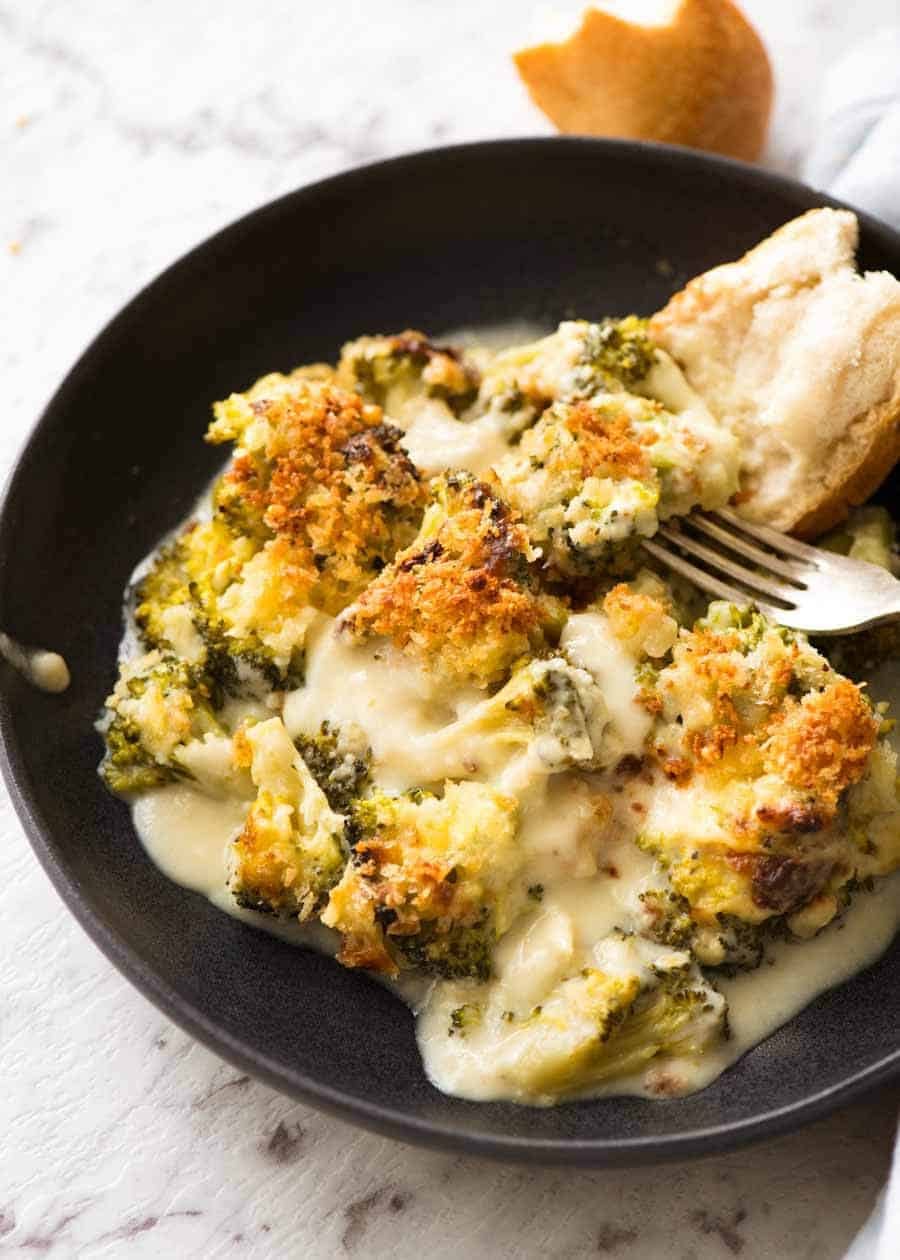 Creamy Garlic Parmesan Broccoli Casserole in a rustic dark bowl, ready to be eaten.