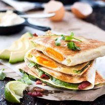 Whole Egg, Bacon and Avocado Breakfast Quesadillas - breakfast just got a whole lot more interesting! Love cutting into the quesadilla and discovering the whole egg inside!