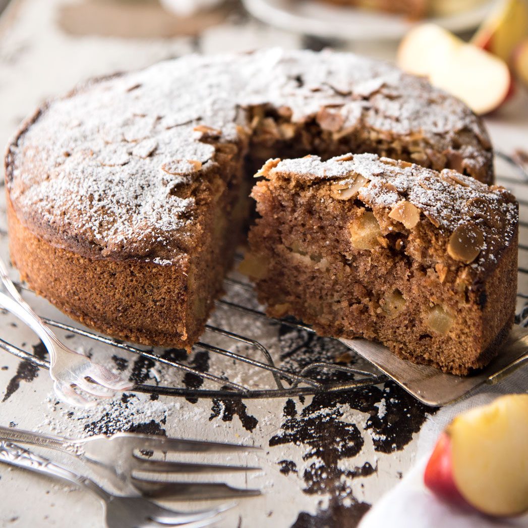 Apple cake on a white cake stand, ready to be served