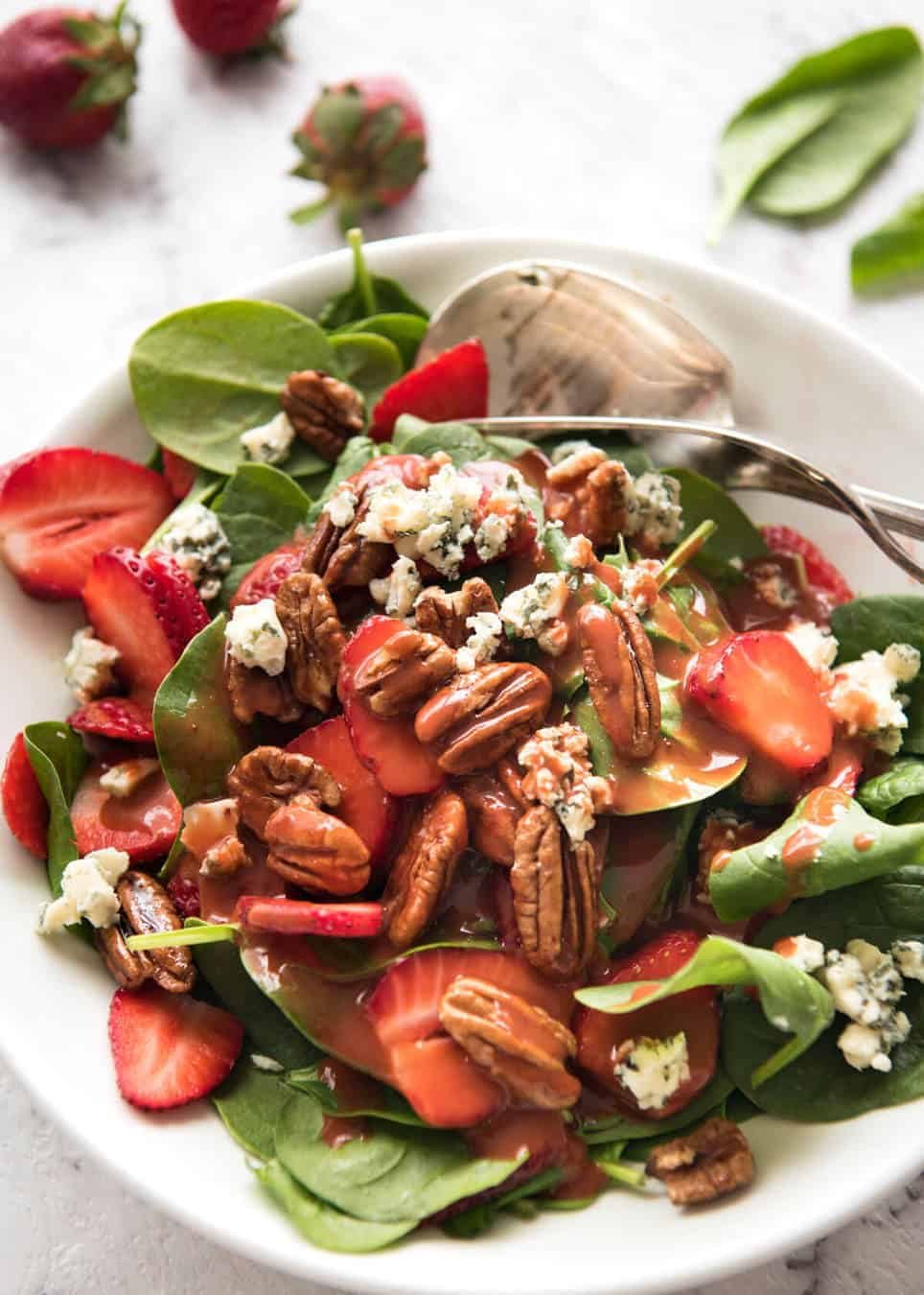 A stunning Chef recipe for a Strawberry Spinach Salad. Spinach, fresh strawberries, blue cheese and candied pecans with a Strawberry Balsamic Dressing. recipetineats.com