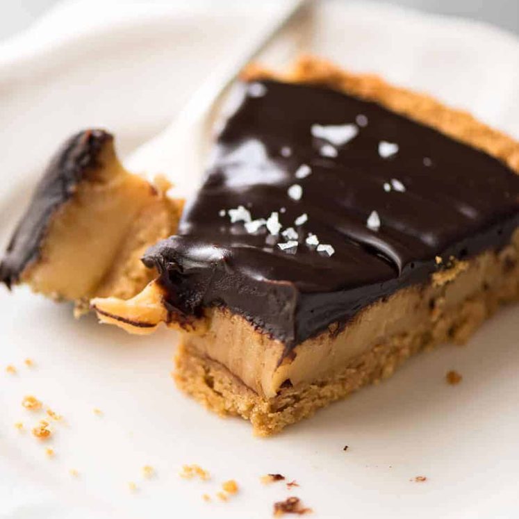 A sinfully decadent Salted Caramel Tart with a creamy soft salted caramel filling topped with luxurious chocolate ganache. Just SIX ingredients! recipetineats.com