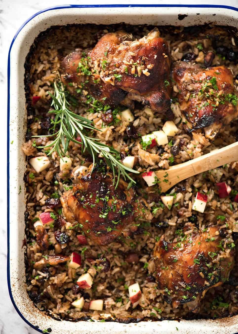 A flavour loaded one-pan, quick midweek dinner - Baked Chicken and Rice Pilaf with Cranberries, Walnuts and Apple. The smell when this is cooking is amazing! www.recipetineats.com