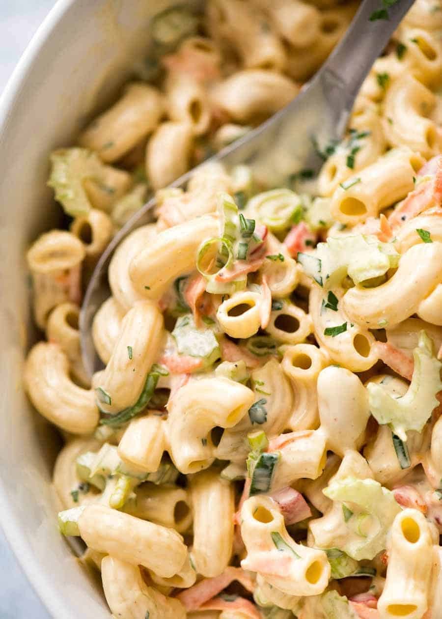 Close up of Macaroni Salad with Creamy Dressing in a white bowl.