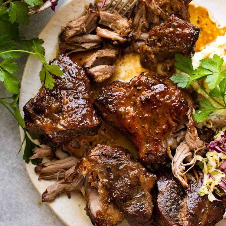 Overhead photo of Brown Sugar Garlic Butter Roast Pork on a plate with a side of cabbage salad