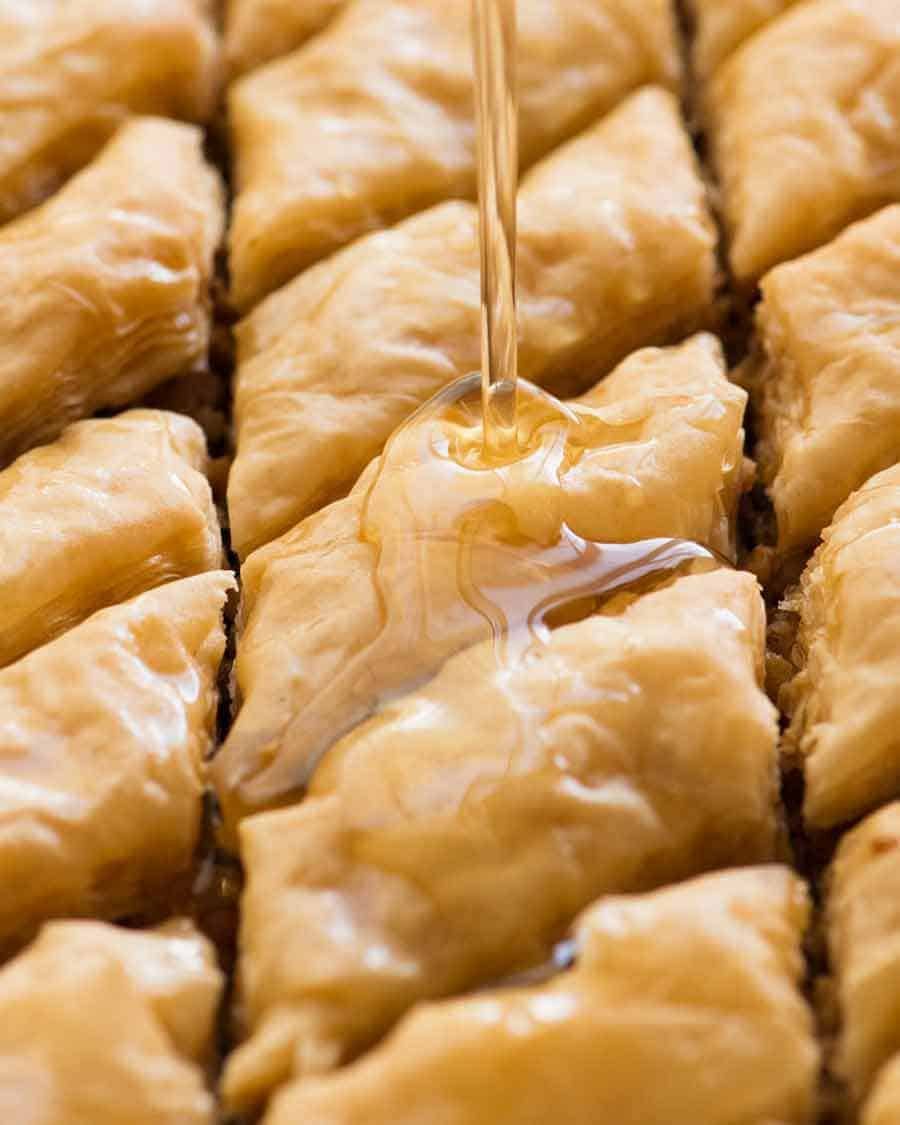 Pouring syrup over Baklava