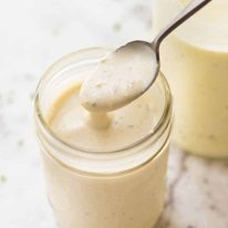 Close up of jar with Healthy Caesar salad Dressing (no mayo yoghurt dressing)