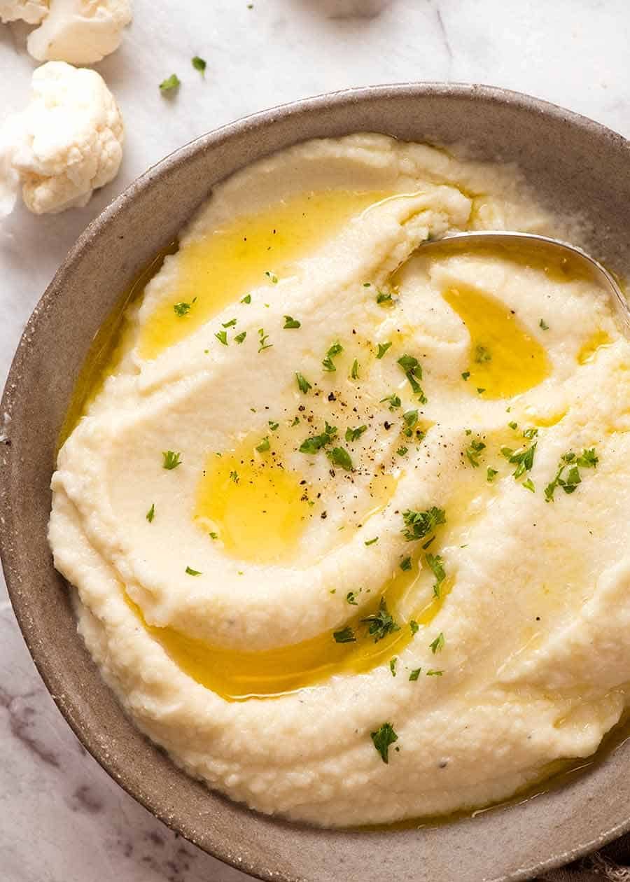 Cauliflower Mashed Potato in a rustic bowl drizzled with melted butter, ready to be served.