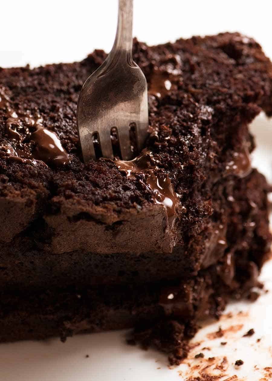 Close up of fork cutting into a stack of Chocolate Zucchini Bread slices