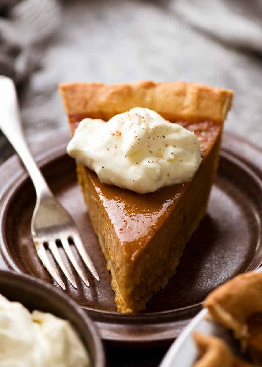 Slice of Pumpkin Pie on a plate with whipped cream