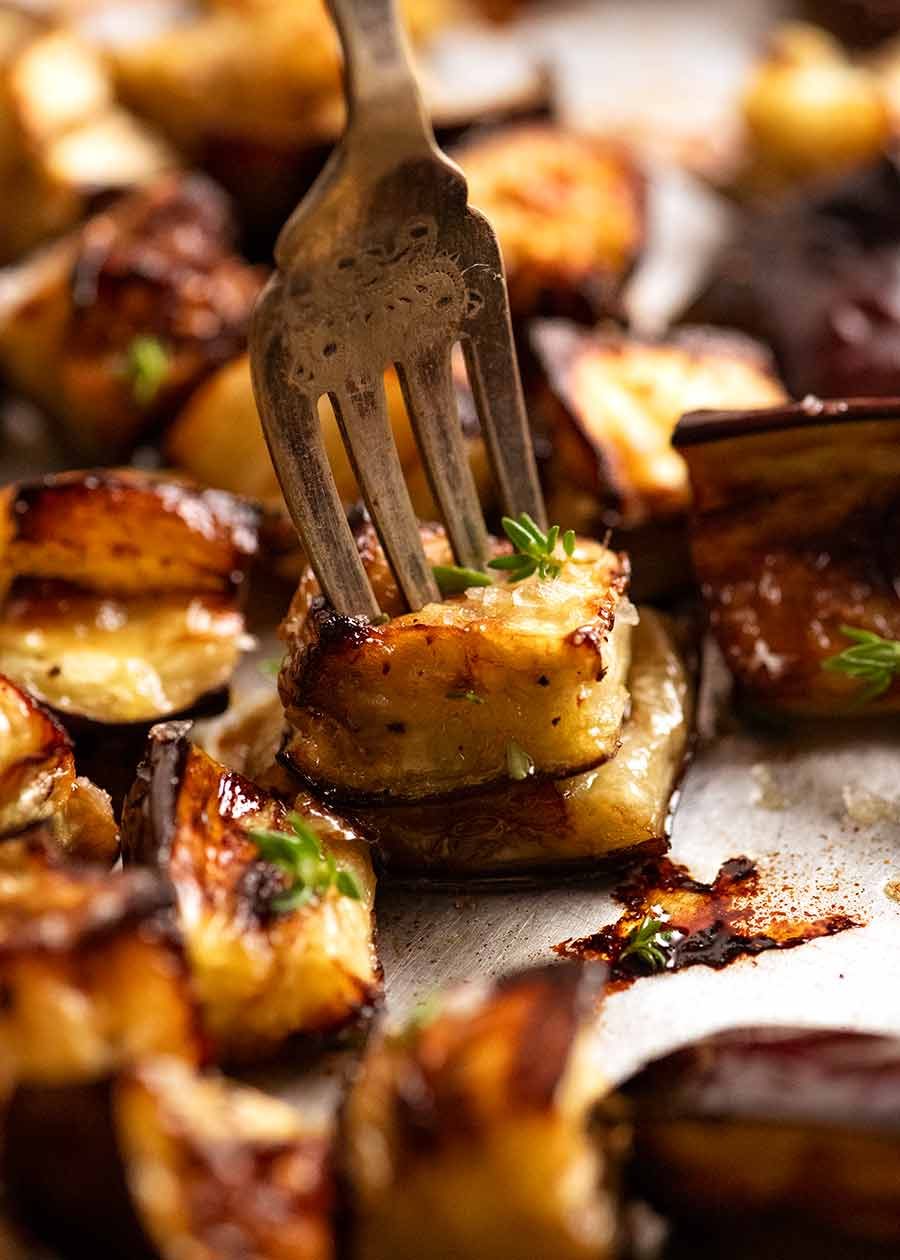 Close up of fork picking up Oven Roasted Eggplant
