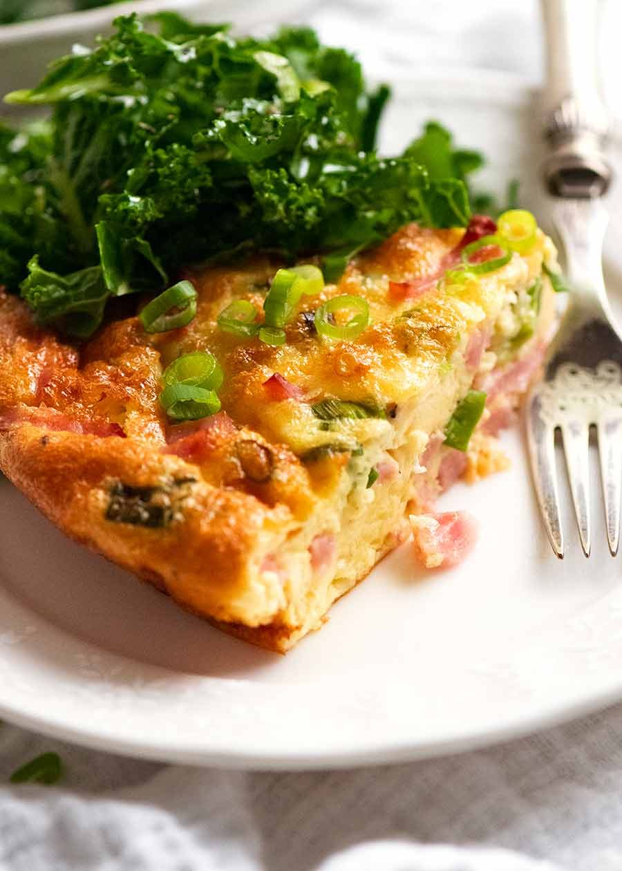 Crustless Quiche on a plate with a side salad