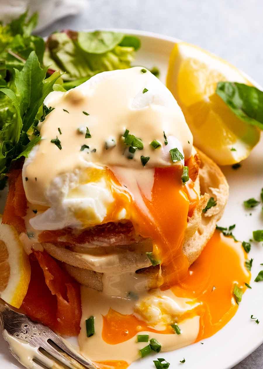Eggs Benedict on a plate showing runny yolk inside