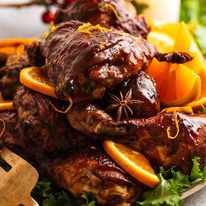 Close up of pile of Sticky Glazed Christmas Chicken