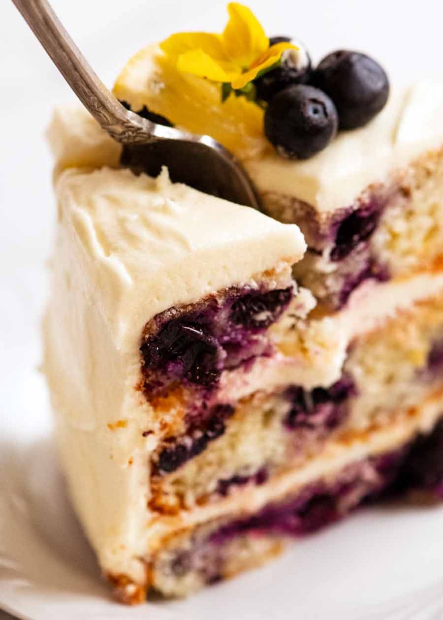 Fork cutting into Blueberry Cake with Lemon Cream Cheese Frosting