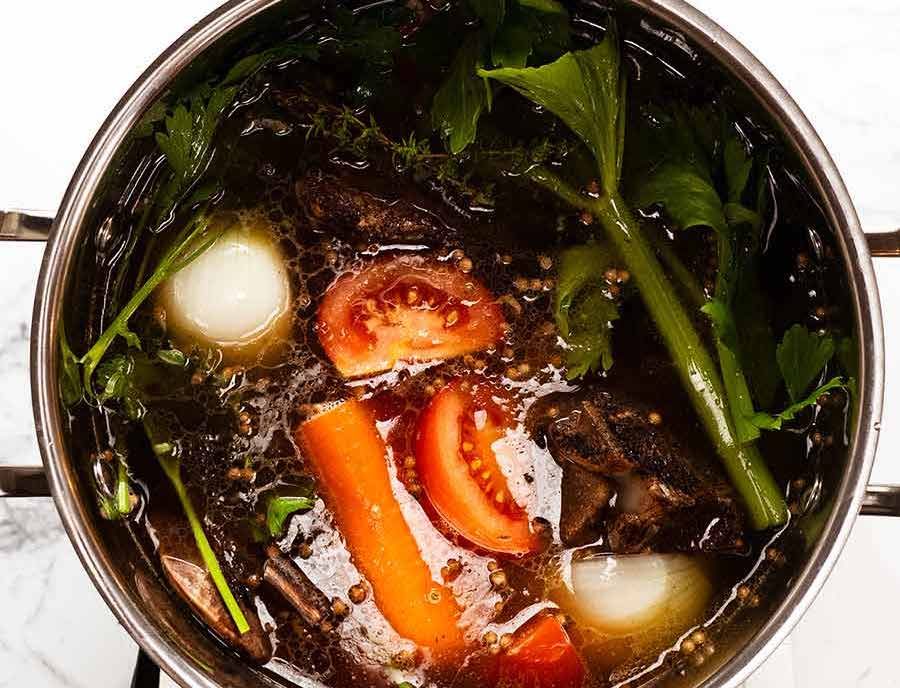 Pot of Homemade Beef Stock simmering on the stove