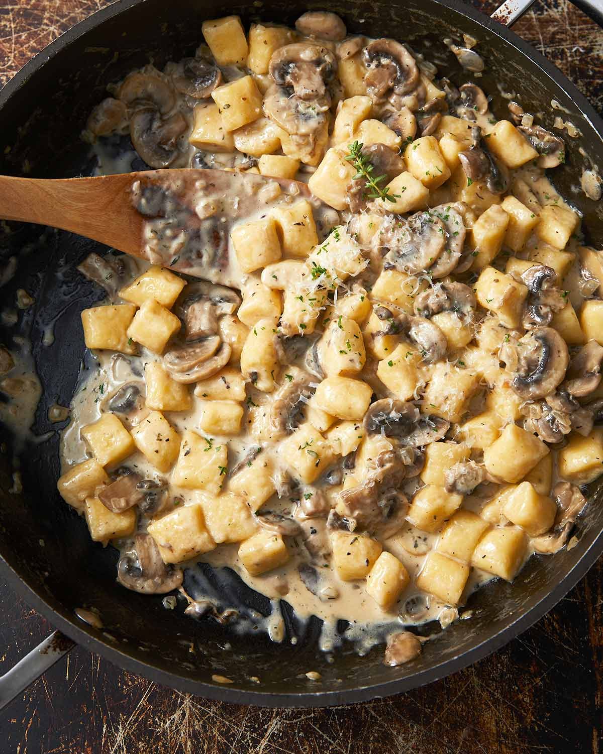 Ricotta gnocchi with creamy mushroom sauce in a pan ready to serve